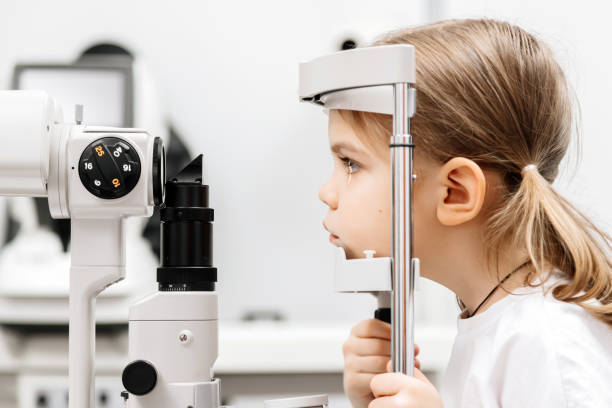 istock Close-up of a little girl with deep eyes undergoing vision diagnostics using a slit lamp in an ophthalmology clinic. A perfect moment highlighting the importance of caring for children's vision. 2175599650