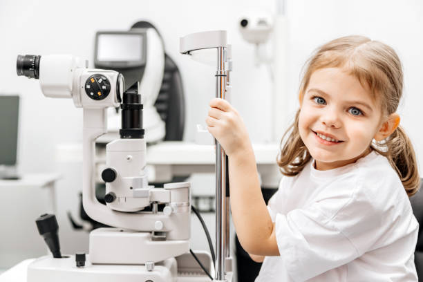 istock Close-up of a little girl with deep eyes undergoing vision diagnostics using a slit lamp in an ophthalmology clinic. A perfect moment highlighting the importance of caring for children's vision. 2175599652