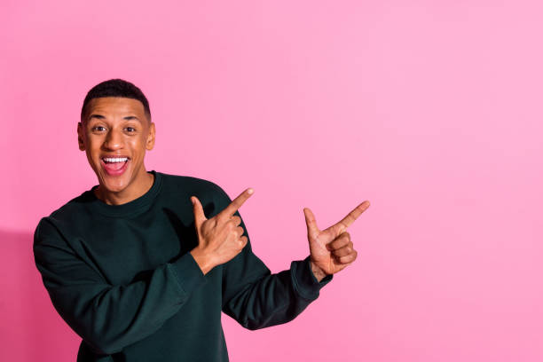 istock Photo of cheerful positive guy dressed pullover pointing two fingers emtpy space isolated pink color background 2175603964