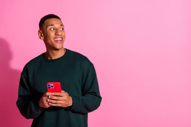 istock Photo of funky cool guy dressed pullover texting modern device emtpy space isolated pink color background 2175604036