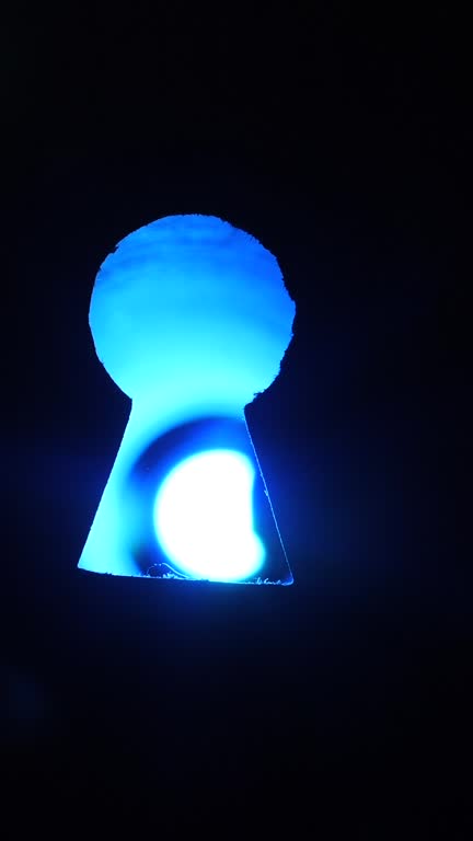 vertical video Lightbulb emerging through a keyhole, illuminating a dark space