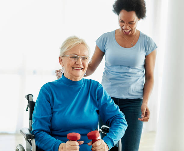 istock senior care exercise physical therapy exercising help assistance retirement home physiotherapy physiotherapist fitness gym stretch band clinic therapist elderly woman band stretching 2175606903