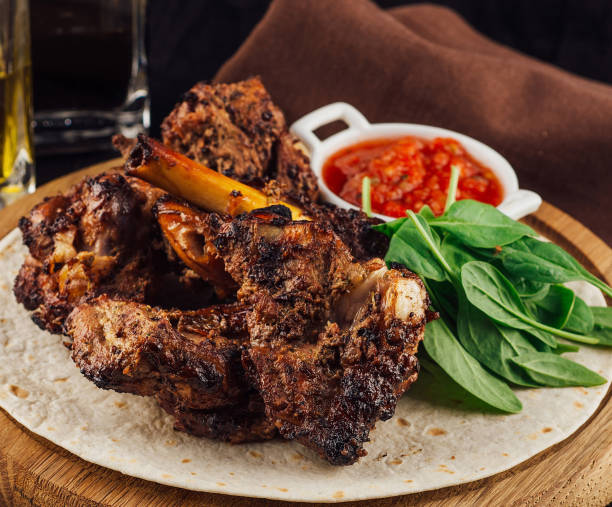istock Grilled lamb shank with tomato salsa and spinach on flatbread 2175607404