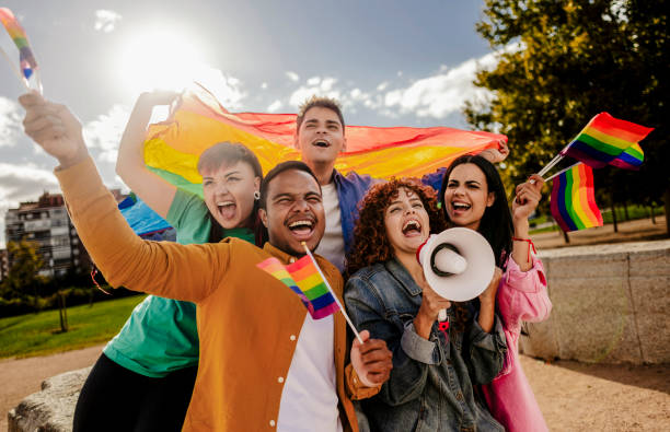 istock Enthusiastic Group Celebrating LGBTQ Pride with Flags and Megaphone 2175608307