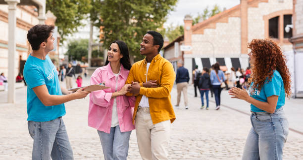 istock Volunteers Engaging with a Couple at an Outdoor Event 2175608321