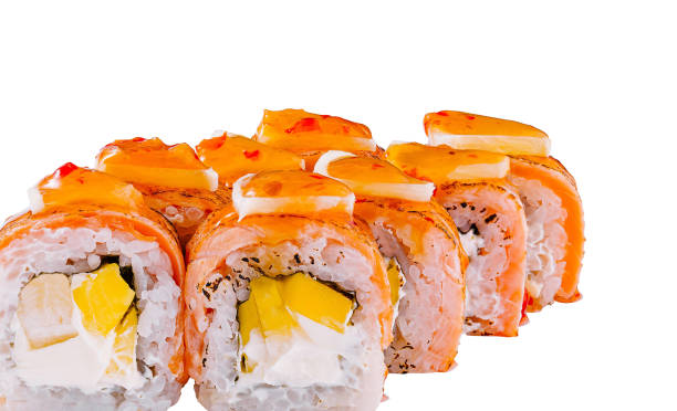 istock Sushi rolls with salmon, mango, cream cheese and sauce standing in line on white background 2175608538
