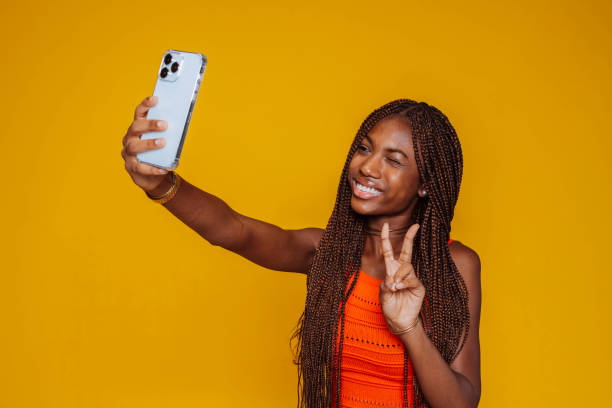 istock African young smiling woman takes selfie at studio 2175609302