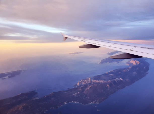 A breathtaking view from the airplane window, showcasing the wing in flight above the Adriatic Sea with beautiful Croatian islands in the distance. The scene evokes a sense of adventure and wanderlust, while the blend of sea and sky from a bird's-eye perspective enhances the magic of travel