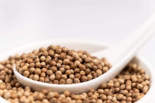 istock Coriander Grains in a Spoon on a White Background. 2175613810