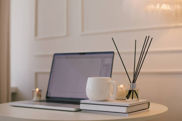 istock Laptop and white mug with tea on a table. Workspace in a modern room. 2175614081