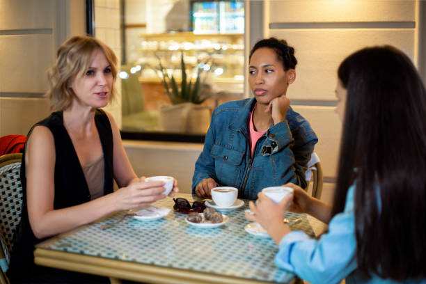 istock Group of women chatting over coffee at cafe 2175615014