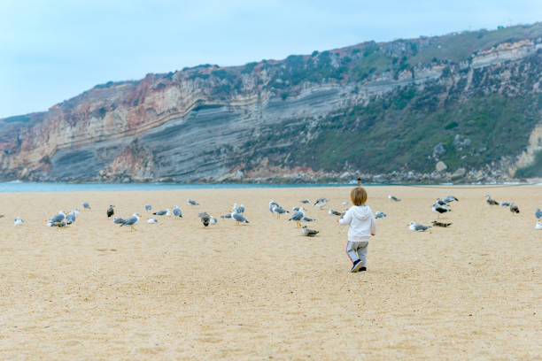 seasonal outdoor activities, back view. Sea holidays, travel and beach holidays in outseason.