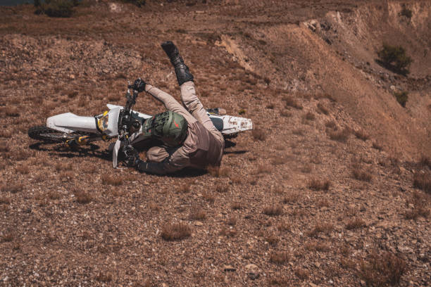 Image of a motocross rider falling on the dirt
