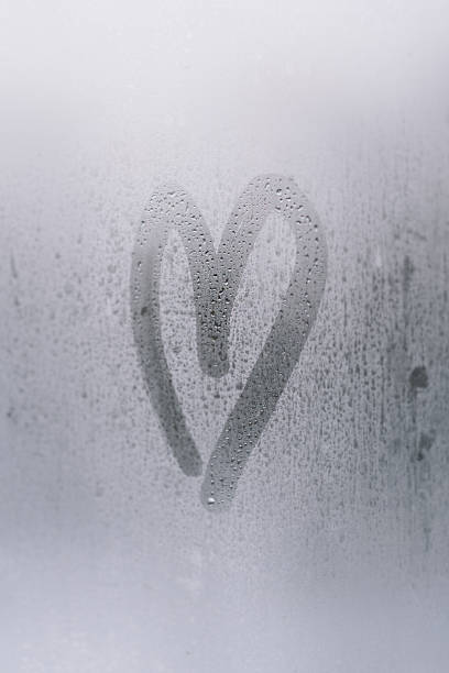 istock Heart shape drawn on a foggy window 2175622803