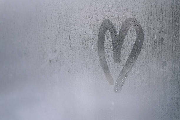 istock Heart shape drawn on a foggy window 2175622808