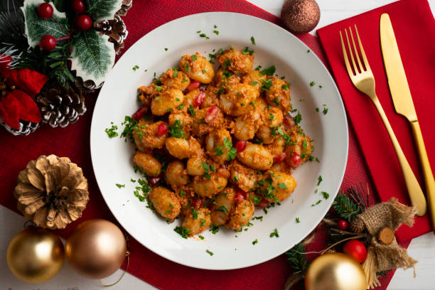 Delicious Italian gnocchi with pesto rosso. Top view table with christmas decorations..