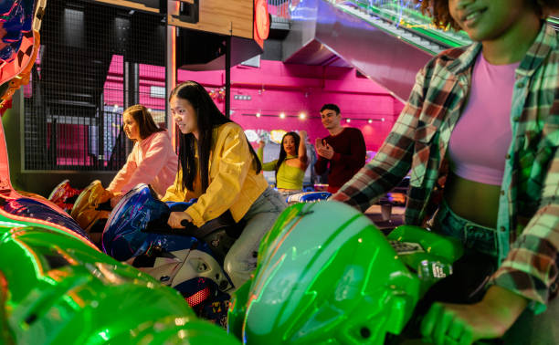 istock Friends Competing in Arcade Motorcycle Racing Game 2175626645