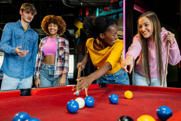 istock Friends Enjoying a Fun and Competitive Game of Pool 2175626745