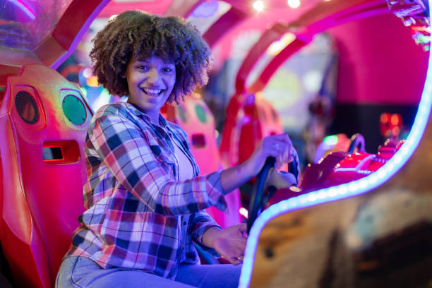 istock Young Woman Enjoying an Arcade Racing Game 2175626792