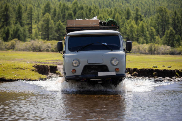 istock Russian off-road van with tourists crossing a river somewhere in Mongolia 2175627296