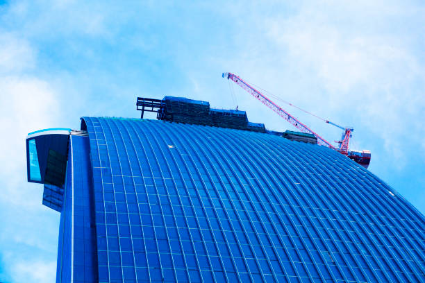 Cranes behind top of new office building in Bangkok Ratchathewi at Phahonyothin Rd