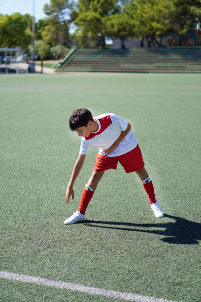 istock teenage boy doing stretching and flexibility before sports training 2175634477