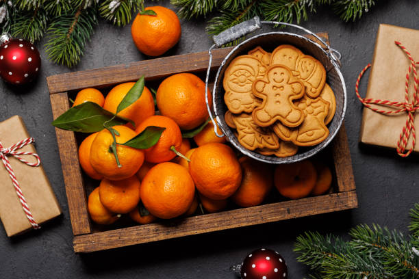 istock Festive citrus joy: Tangerines in a holiday-themed box 2175636309