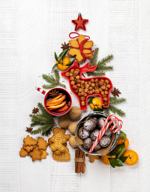 istock Christmas tree-shaped with cookies, surrounded by assorted nuts and festive decor 2175636771