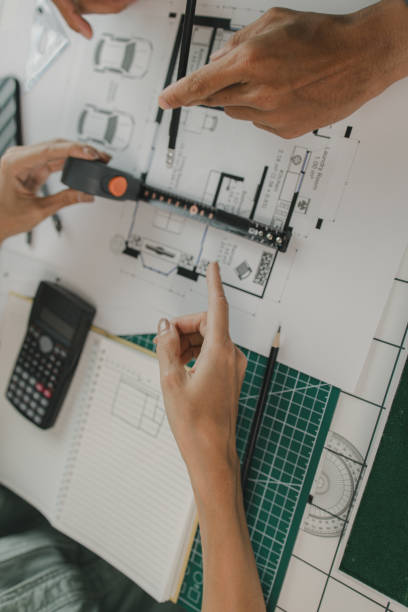 istock an architect and his assistant are brainstorming and examining the blueprints, two engineers are discussing a construction plan to make the structure stronger, draft, meeting, teamwork 2175637964