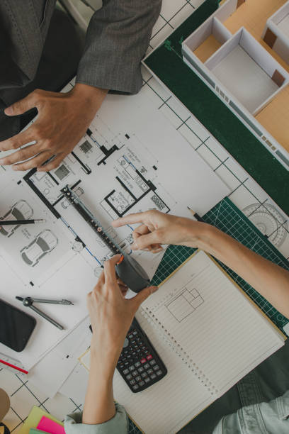 istock an architect and his assistant are brainstorming and examining the blueprints, two engineers are discussing a construction plan to make the structure stronger, draft, meeting, teamwork 2175638008