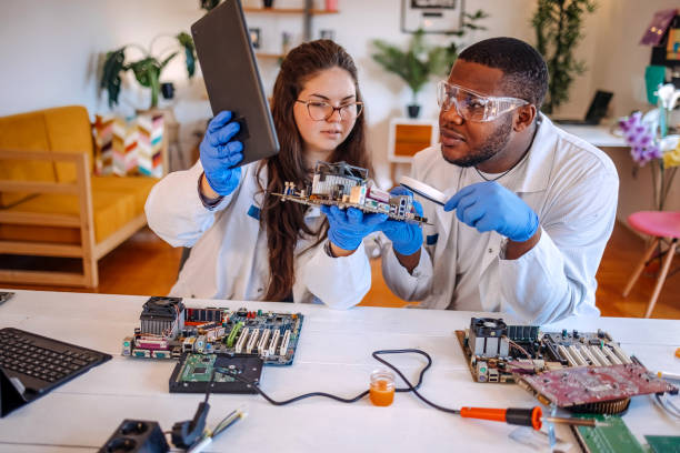 istock University students working together on project at home using electronic parts for computer build and searching for solution on digital tablet 2175639824