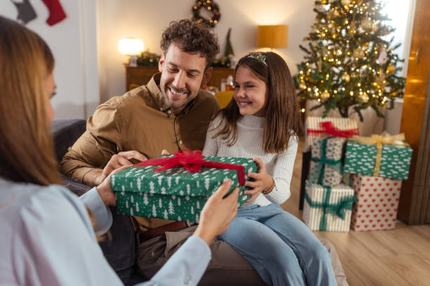 istock Christmas magic: Family exchanging gifts at home 2175640037