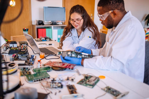 istock University students working together on project at home using electronic parts for computer build and talking about solution with laptop support 2175640980