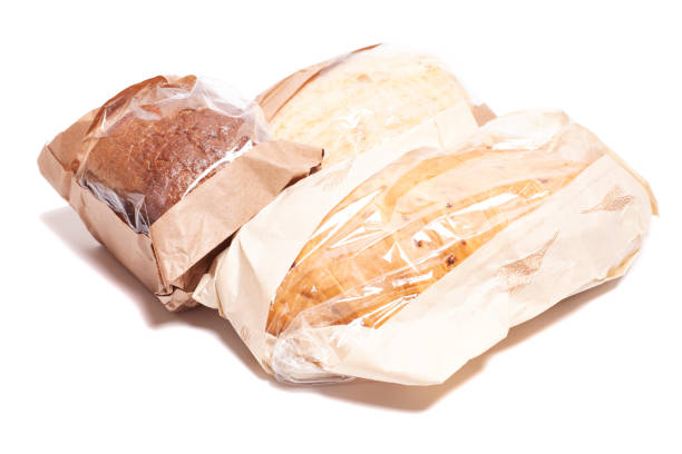 Rye and white bread in a paper bag isolated on white background