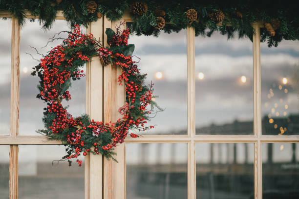 istock Hand made Christmas wreath hanging on a house window. Festive decorations. 2175644191