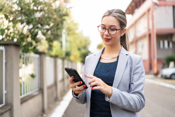 istock Portrait of modern young Caucasian businesswoman, using mobile phone, while commuting through the city 2175644907