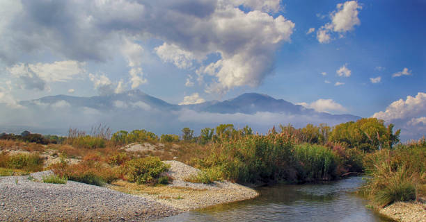 Autumnal landscape with mountains under a beautiful cloudy sky