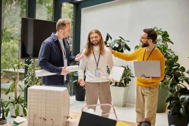 istock Three creative male colleagues collaborating in an inspiring office space surrounded by greenery 2175646029