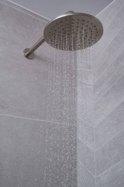 istock Water running from a modern bathroom shower head. 2175648168