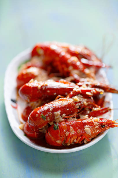 close up of a plate of traditional garlicky spicy sichuan red crawfish