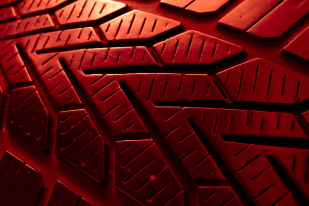 Detailed close-up of a black rubber tire tread pattern, showing texture and grooves for automotive and industrial concepts.