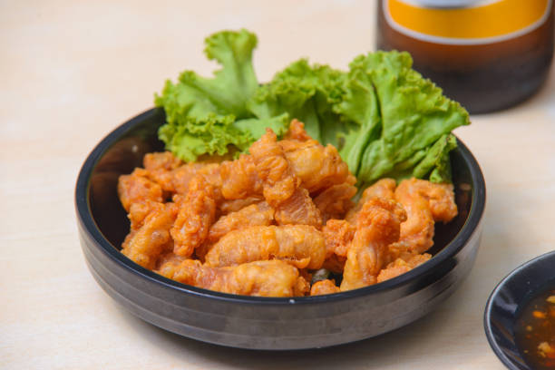 Popular snacks in the restaurant at Thailand. Deep fried chicken tendons.