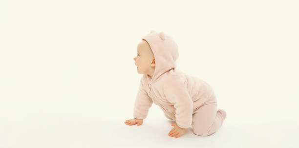 istock Happy cute baby crawling on the floor looking away on white background 2175652349