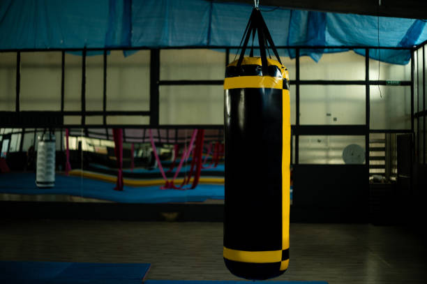 istock Black and yellow punching bag in gym 2175653312