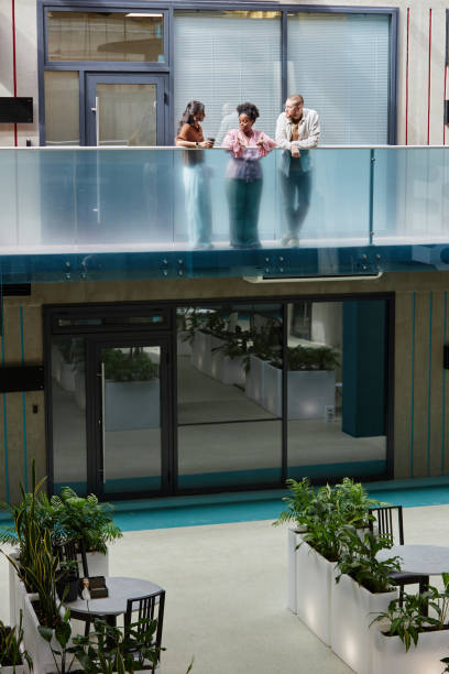 istock Diverse Group of Colleagues Chatting while Standing on Second Floor of Business Building 2175655058