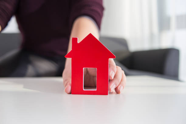 istock businessmen hold house model in hand 2175655496
