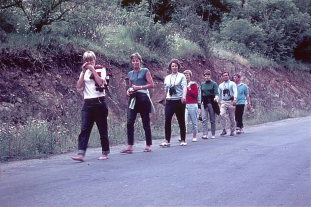 Franconia, Bavaria, Germany, 1970. Hiking group on a country road.