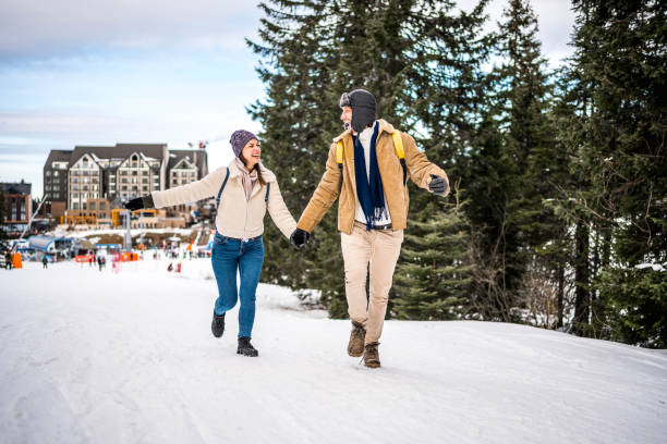 Couple running outdoors in snow Cheerful young couple running on a winter day in a snowy mountain mountain mountain peak balkan mountains serbia stock pictures, royalty-free photos & images