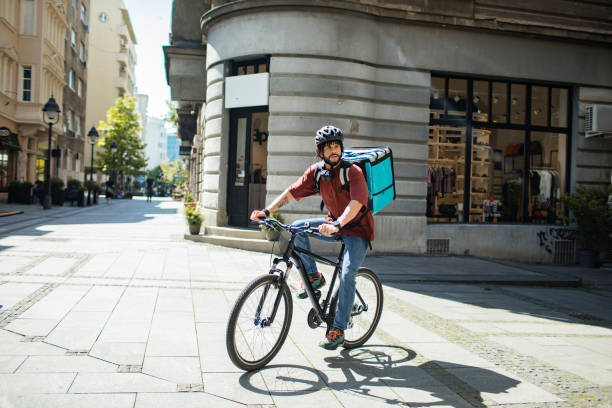 istock Young man delivering food on a bicycle in a city 2175659611