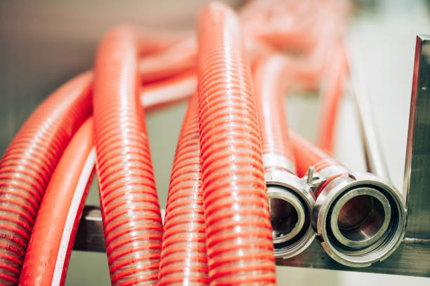 Close up shot of some flexible red hoses with metal nozzles.